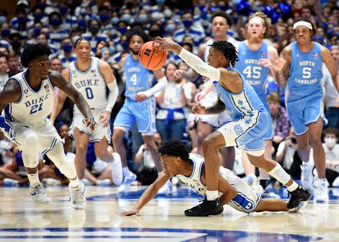 Mar 5, 2022; Durham, North Carolina, USA; North Carolina Tar Heels guard Caleb Love(2) grabs a loose ball in front of Duke Blue Devils guard Jeremy Roach (3) during the second half at Cameron Indoor Stadium. The Tar Heels won 94-81.